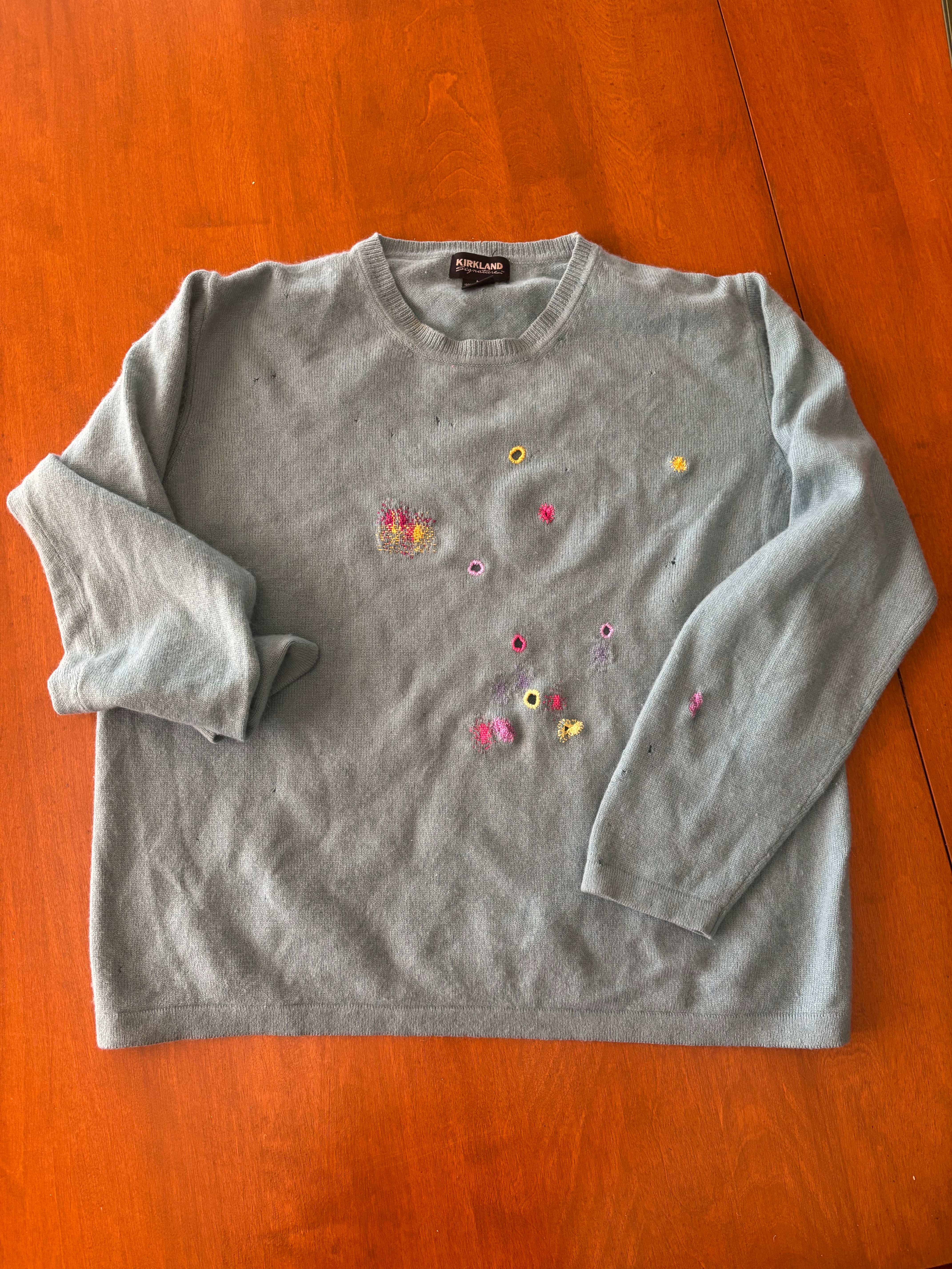 Gray cashmere sweater with colorful visible darning repairs