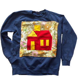 Navy sweatshirt with an appliqued red house quilt block on a floral background